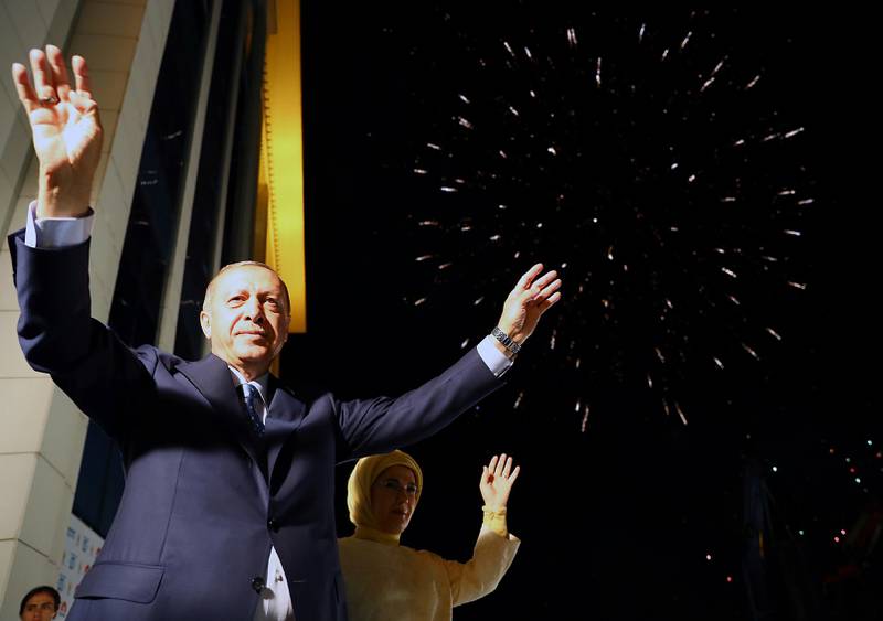 Turkey's President Recep Tayyip Erdogan, accompanied by his wife Emine waves to supporters of his ruling Justice and Development Party (AKP) in Ankara, Turkey, early Monday, June 25, 2018. Erdogan won Turkey's landmark election Sunday, the country's electoral commission said, ushering in a new system granting the president sweeping new powers which critics say will cement what they call a one-man rule (Presidency Press Service via AP, Pool)