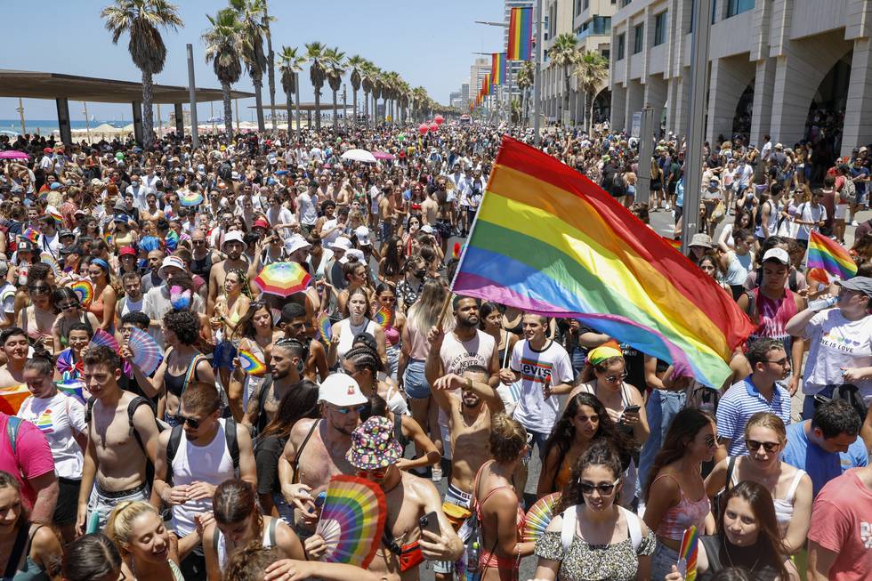 FILE - In this June 25, 2021 file photo, people participate in the annual Pride Parade, in Tel Aviv, Israel.  On Sunday, July 11, 2021, Israel’s Supreme Court cleared the way for same-sex couples to have children through surrogate mothers, a move hailed by lawmakers and activists as a victory for LGBTQ rights. (AP Photo/Ariel Schalit, File)
