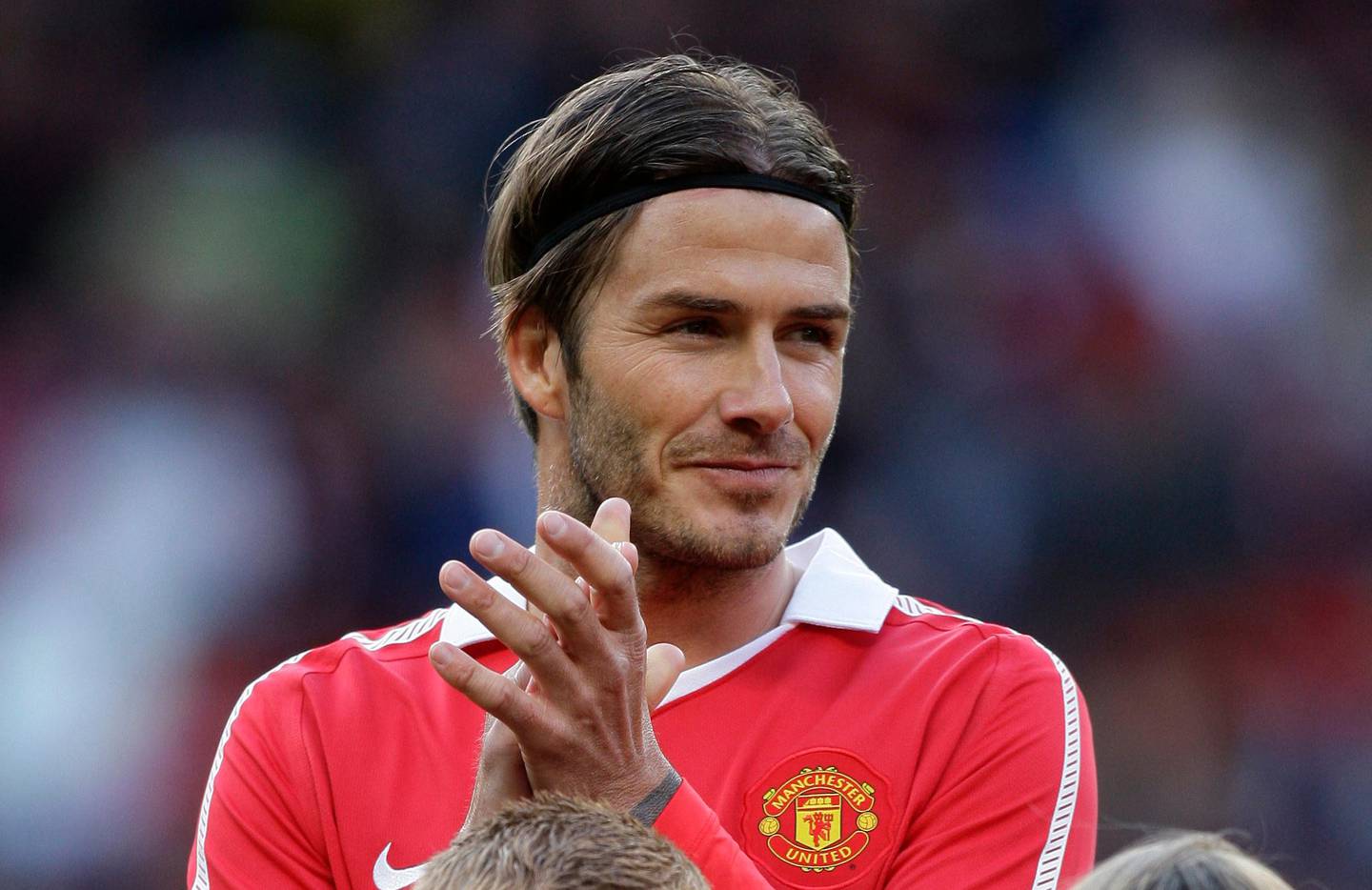 Former Manchester United player David Beckham applauds before his team's friendly soccer match against Juventus at Old Trafford Stadium, Manchester, England, Tuesday May 24, 2011. (AP Photo/Jon Super)   
