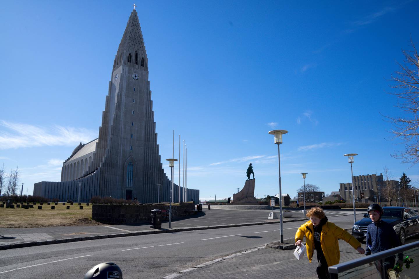 In this photo taken on Wednesday, April 29, 2020, two local boys walk past the the empty plaza of Hallgrimskirkja Church, a popular tourist destination in downtown Reykjavik. High schools, dentists and hair salons are about to reopen in Iceland, which has managed to get a grip on the coronavirus through the worlds most extensive regime of testing. By identifying infected people even when they had no symptoms, the tiny North Atlantic nation managed to identify and isolate cases where many bigger countries have struggled. (AP Photo/Egill Bjarnason)