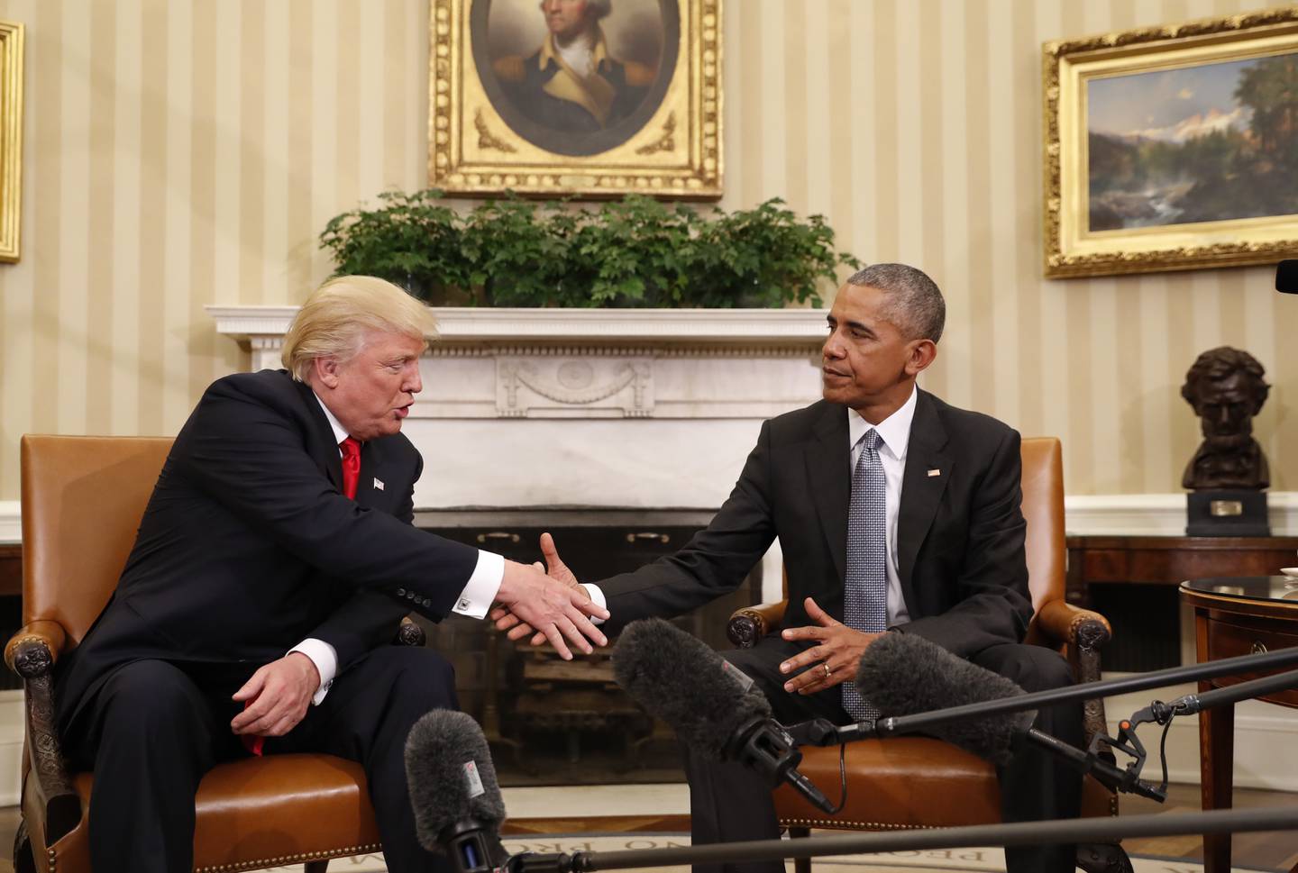 President Barack Obama shakes hands with President-elect Donald Trump in the Oval Office of the White House in Washington, Thursday, Nov. 10, 2016. President Trump and his allies are harking back to his own transition four years ago to make a false argument that his own presidency was denied a fair chance for a clean launch. Press secretary Kayleigh McEnany laid out the case from the White House podium last week. Obama, who had portrayed Trump as an existential threat to the nation, invited the president-elect to the White House and visited with him in the Oval Office. Obama's aides also offered help to Trump's incoming staffers. (AP Photo/Pablo Martinez Monsivais)