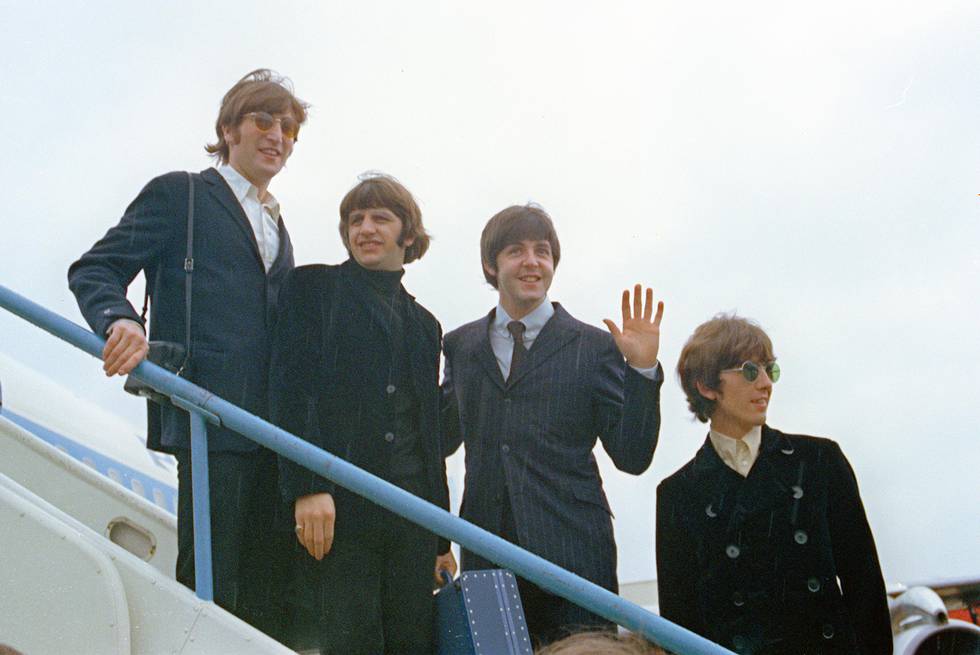 FILE - This 1966 file photo shows The Beatles, from left, John Lennon, Ringo Starr, Paul McCartney and George Harrison as they leave London Airport on their trip to the U.S. and Canada. Hundreds of books have been written about the band, but none with such care and authority as those by the 58-year-old British author Mark Lewisohn. Lewisohn is in the midst of a 3-volume biography of the Beatles and most recently contributed text for a coffee table book about their landmark film ?ÄúA Hard Day?Äôs Night.?Äù (AP Photo/File)