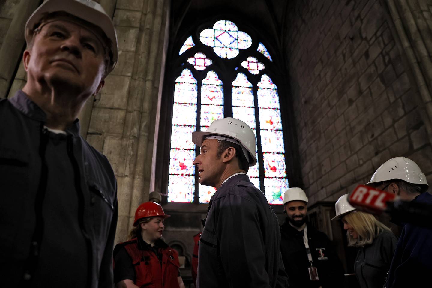 French President Emmanuel Macron, center, and French Army General Jean-Louis Georgelin, left, in charge of Notre-Dame Cathedral reconstruction, visit the reconstruction site of the Notre-Dame de Paris cathedral, Friday, April 15, 2022 in Paris, to mark three years since the devastating fire. (Ian Langsdon, Pool via AP)