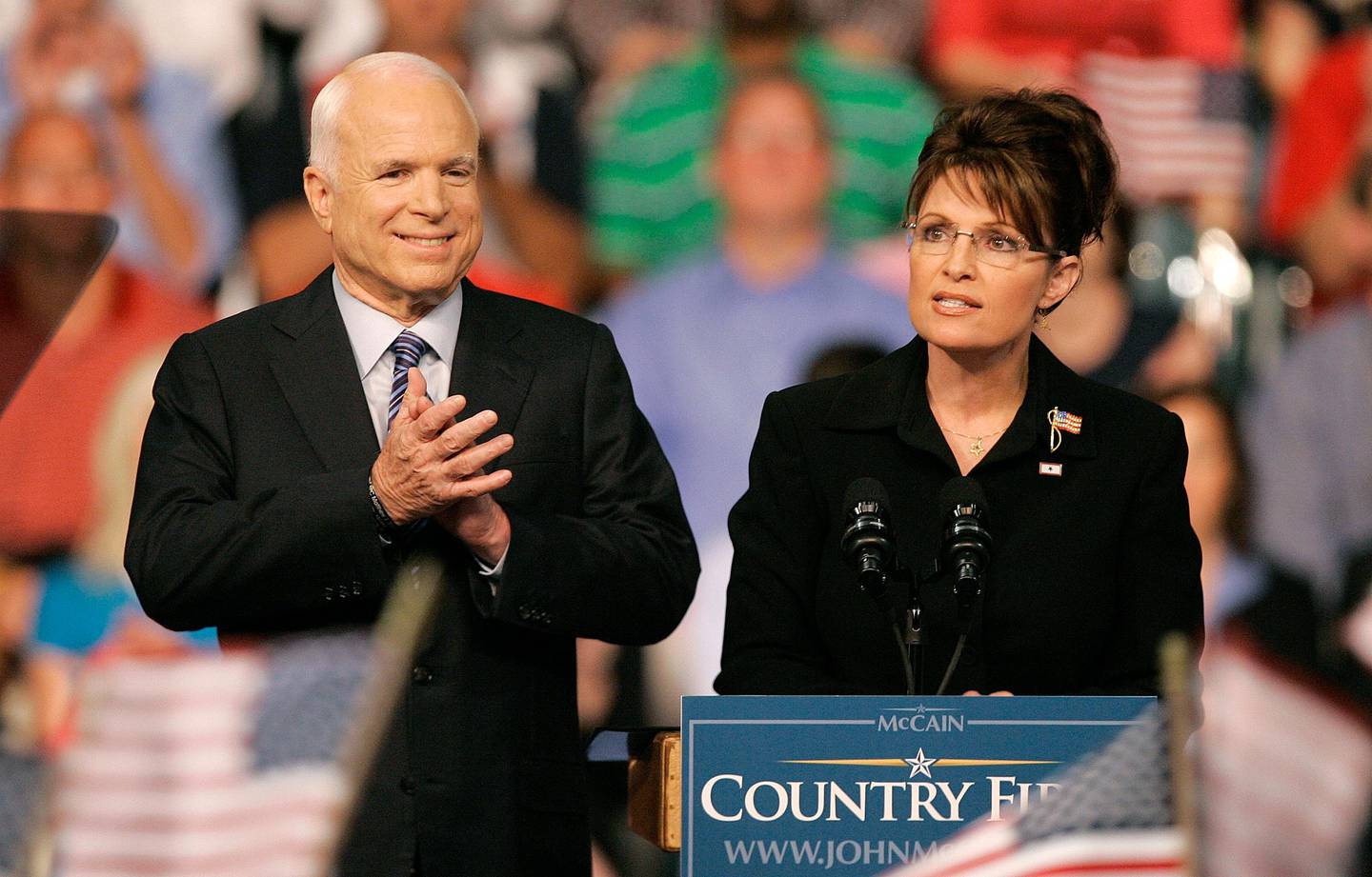 FILE - In this Aug. 29, 2008, file photo, Republican Alaska Gov. Sarah Palin, right, delivers a speech as Republican presidential candidate, Sen. John McCain, R-Ariz., introduces her as his vice presidential running mate at Wright State University's Ervin J. Nutter Center in Dayton, Ohio. Eight years after stumping across the nation as the Republican Party's presidential candidate, McCain is back on the campaign trail in his home state as he faces a primary challenge and a strong Democratic opponent, State Sen. Kelli Ward, in the general election. (AP Photo/Kiichiro Sato, File)