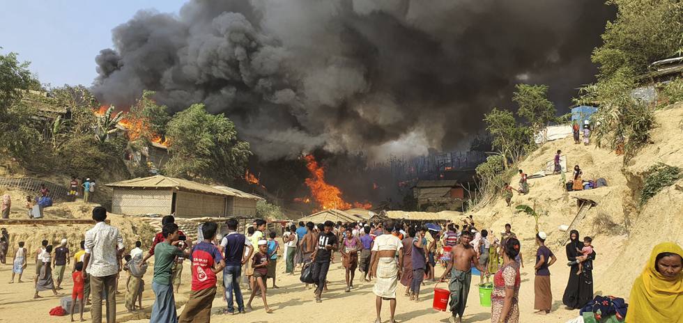 Smoke rises following a fire at the Rohingya refugee camp in Balukhali, southern Bangladesh, Monday, March 22, 2021. The fire destroyed hundreds of shelters and left thousands homeless, officials and witnesses said. (AP Photo/ Shafiqur Rahman)