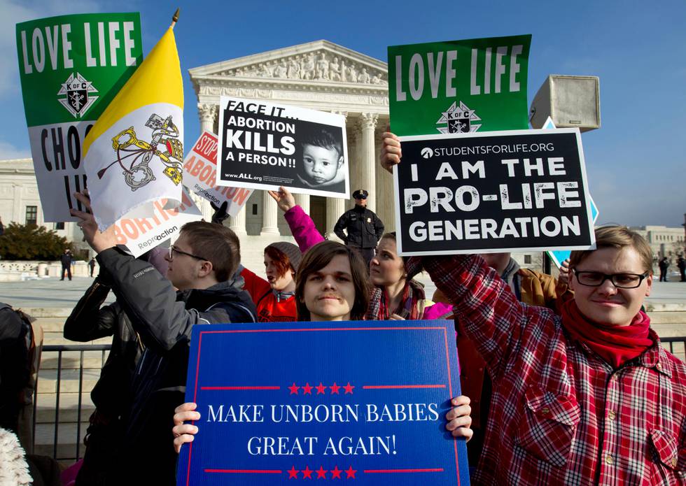 FILE - In this Jan. 18, 2019, file photo, anti-abortion activists protest outside of the U.S. Supreme Court, during the March for Life in Washington. Emboldened by the new conservative majority on the Supreme Court, anti-abortion lawmakers and activists in numerous states are pushing near-total bans on the procedure in a deliberate frontal attack on Roe v. Wade. (AP Photo/Jose Luis Magana, File)