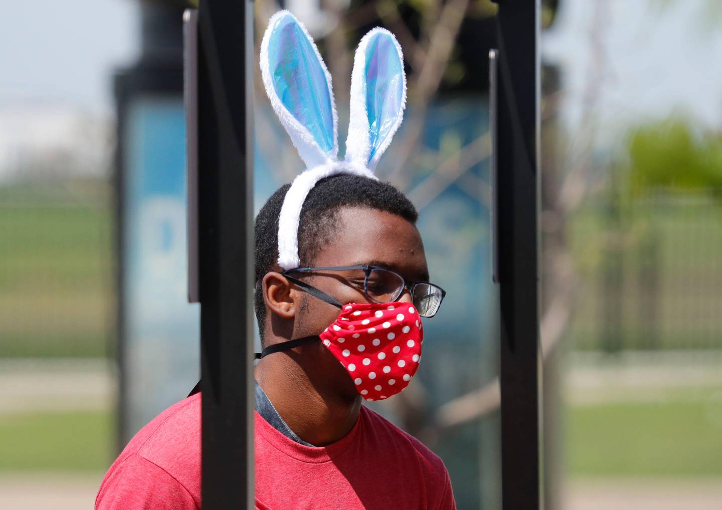 Amid COVID-19 concerns, a fast food worker wears a mask and Easter bunny ears as he works at a Chick-fil-A restaurant in Dallas, Tuesday, April 7, 2020. (AP Photo/LM Otero)