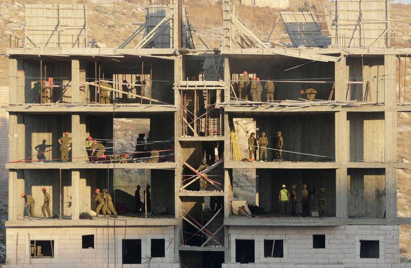 Israeli forces destroy a building in a Palestinian village of Sur Baher, east Jerusalem, Monday, July 22, 2019. Israel says the 10 buildings, located on the West Bank side of the security barrier, were erected too close to the structure. (AP Photo/Mahmoud Illean)