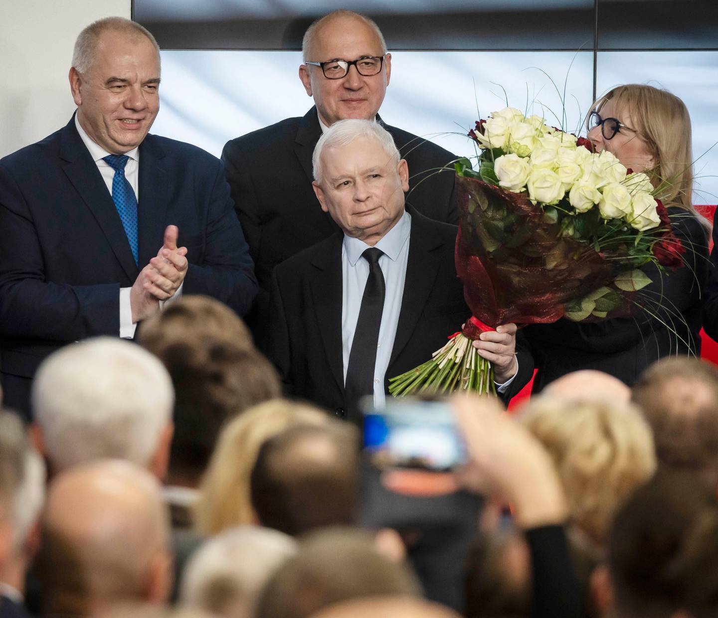 Leader of Poland's ruling party Jaroslaw Kaczynski, center, and party activists react to exit poll results right after voting closed in the nation's parliamentary election that is seen crucial for the nation's course in the next four years, in Warsaw , Poland, on Sunday, Oct. 13 ,2019. (AP Photo)