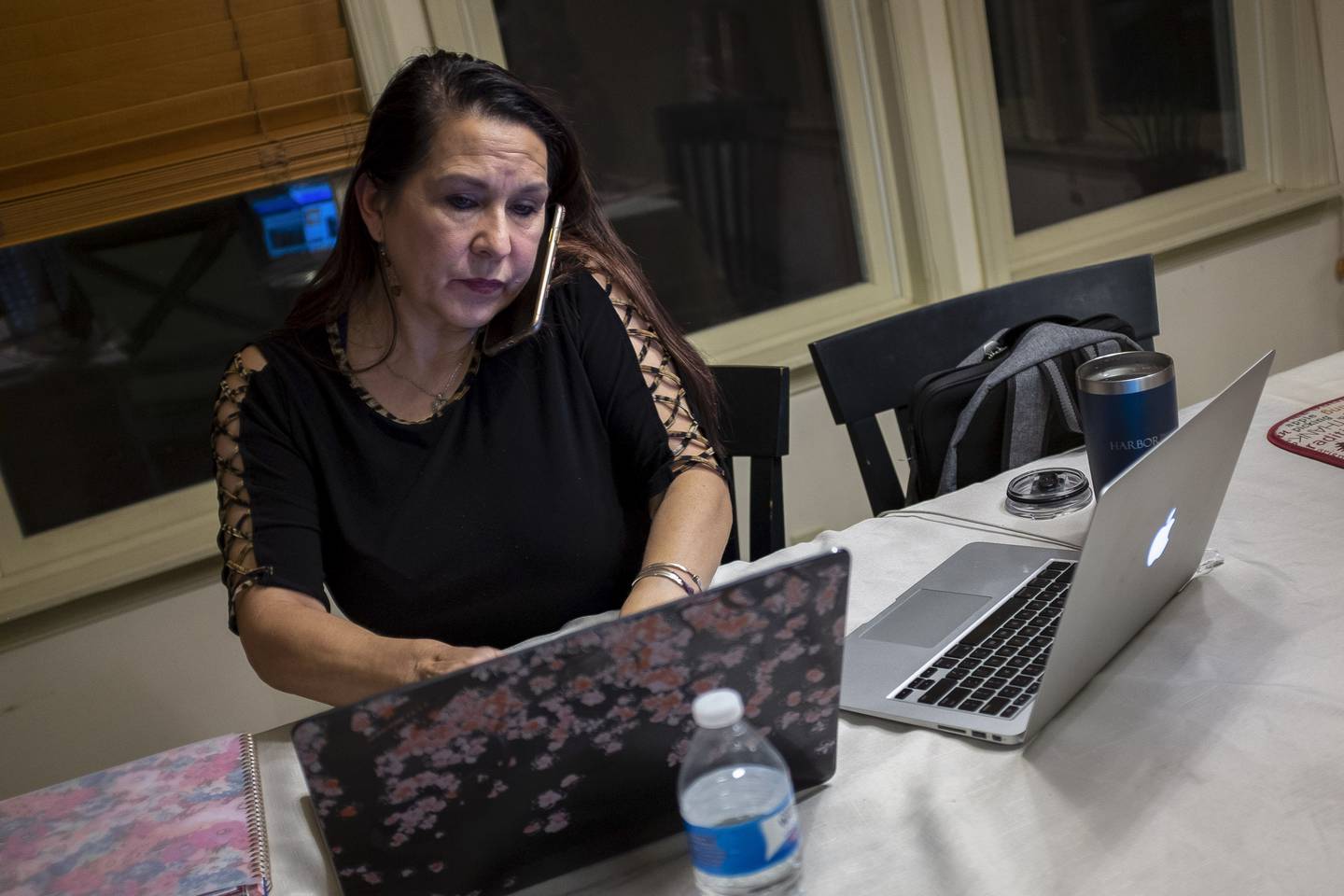 Natalie Abbas sits at her dining room table, in her "Command Post," in Myersville, Md., Tuesday, Jan. 19, 2021, the day before the presidential inauguration. Abbas, 59, says her conviction that the election was stolen from Trump is as strong as her belief in God. (AP Photo/Cliff Owen)