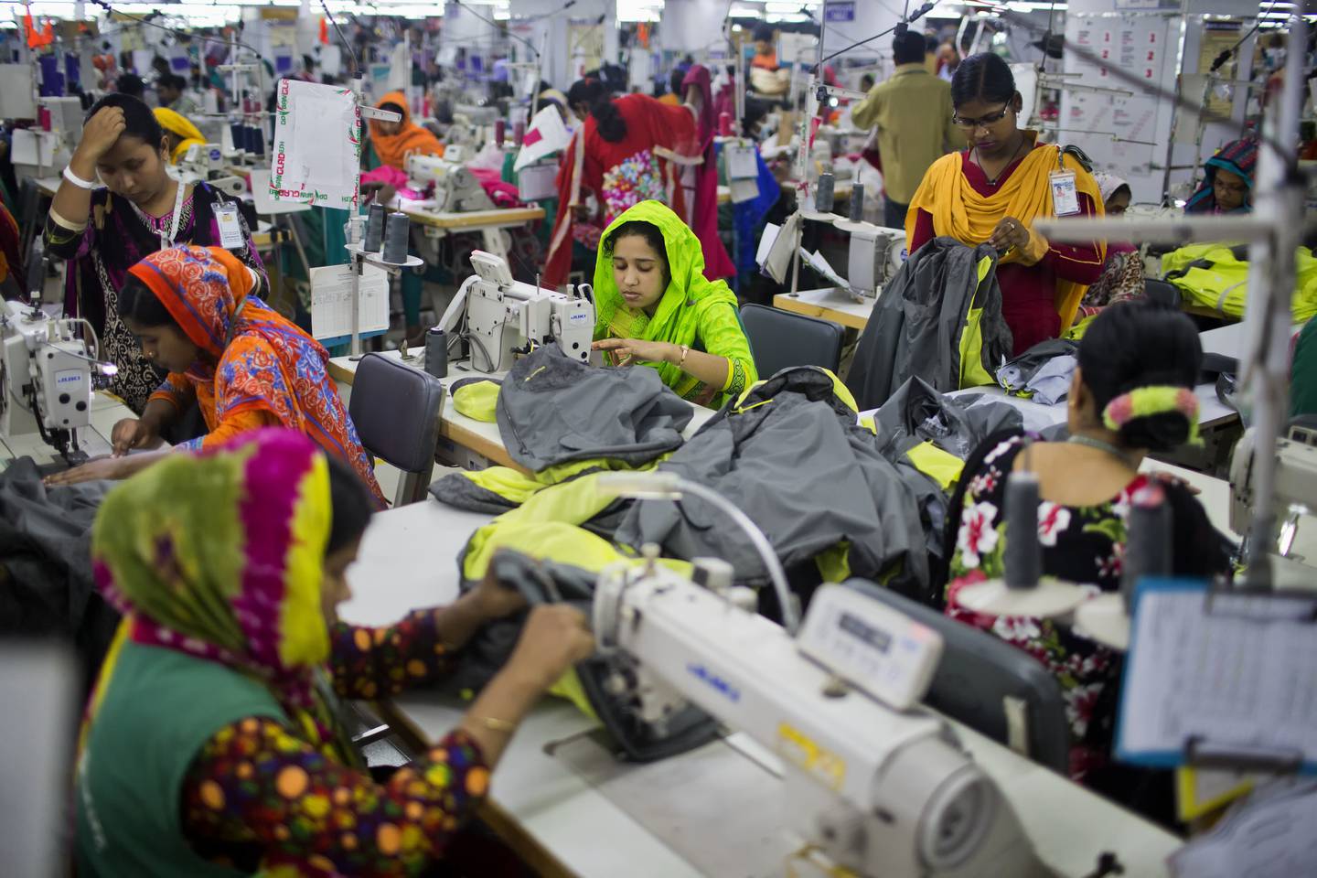 FILE - In this April 19, 2018 photo, Bangladeshis work at Snowtex garment factory in Dhamrai, near Dhaka, Bangladesh. A group set up by European clothing brands that has monitored factory safety in Bangladesh for years plans to leave, with its duties being assumed by a local group including unions and industry figures in the world's second-largest garment manufacturer. The European group and a separate North American group were formed after the collapse of Rana Plaza, a building housing five garment factories that made clothing for international brands. The departure, which officials said Thursday, Jan. 16, 2019, was planned for May, follows a protracted tussle with garment manufacturers who wanted Bangladesh's government to form a local watch group to monitor the sector. (AP Photo/A.M. Ahad)