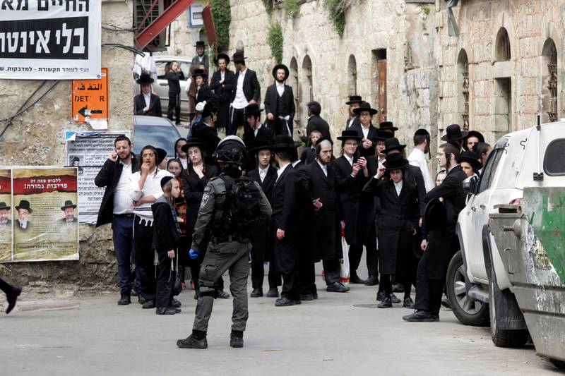 Ultra Orthodox Jews gather during a protest against government's measures to stop the spread of the coronavirus in the orthodox neighborhood of Mea Shearim in Jerusalem, Monday, March 30, 2020. (AP Photo/Mahmoud Illean)
