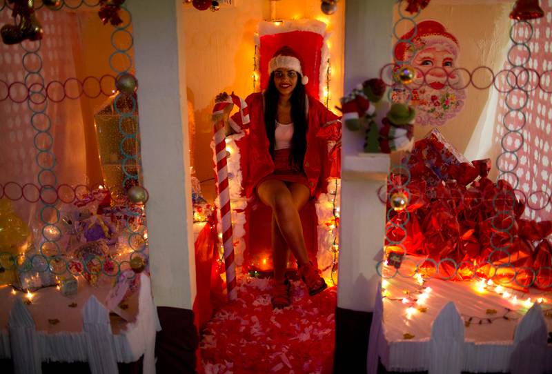 An inmate performs the role of Santa Claus while performing in the 8th annual Christmas event at the Nelson Hungria Prison, in Rio de Janeiro, Brazil, Tuesday, Dec. 12, 2017. Inmates who are serving time for offenses from burglary to homicide, spent weeks decking out the cell blocks with the holiday decorations they created. The inmates used materials they had access to behind bars such as plastic bottles, paper, ground-up Styrofoam and aluminum trays. (AP Photo/Silvia Izquierdo)