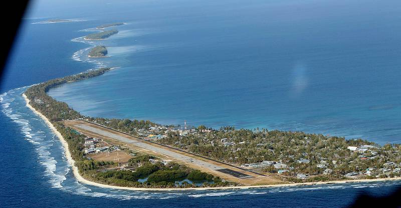In this Oct. 13, 2011 photo, Funafuti, the main island of the nation state of Tuvalu, is seen from a Royal New Zealand airforce C130 aircraft as it approaches at Funafuti, Tuvalu, South Pacific. Funafuti is the capital of Tuvalu, a group of atolls situated north of Fiji and northwest of Samoa, in the South Pacific ocean. The atolls are suffering a severe drought and water shortage, coupled with contaminated ground water due to rising sea levels. The governments of Australia, New Zealand and the United States are providing desalination plants to alleviate the critical water shortage for some 10,000 islanders. (AP Photo/Alastair Grant)