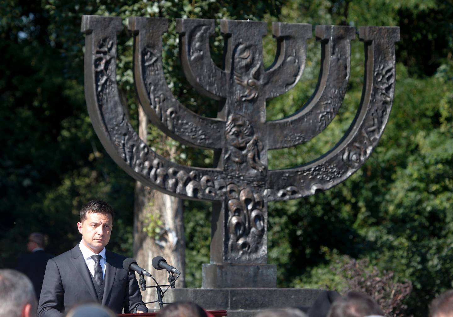 Ukrainian President Volodymyr Zelenskiy delivers his speech at the Menorah monument as he and Israeli Prime Minister Benjamin Netanyahu visit the Babi Yar ravine where Nazi troops machine-gunned many thousands of Jews during WWII, in Kyiv, Ukraine, Monday, Aug 19, 2019. Netanyahu said he plans to discuss ways to expand trade between Israel and Ukraine during the talks with Ukrainian President Volodymyr Zelenskiy. ( AP Photo/Efrem Lukatsky)