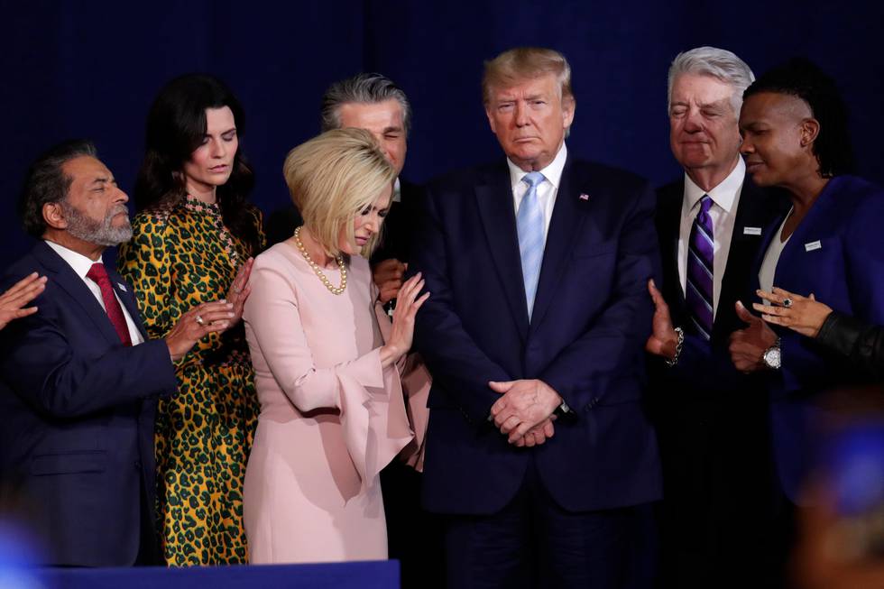 FILE - In this Jan. 3, 2020 file photo, faith leaders pray with President Donald Trump during a rally for evangelical supporters at the King Jesus International Ministry church in Miami. Trump's bond with white evangelical voters has long sparked debate. But misunderstandings persist about his support from a Christian voting bloc that favored the GOP long before he took office. (AP Photo/Lynne Sladky, File)