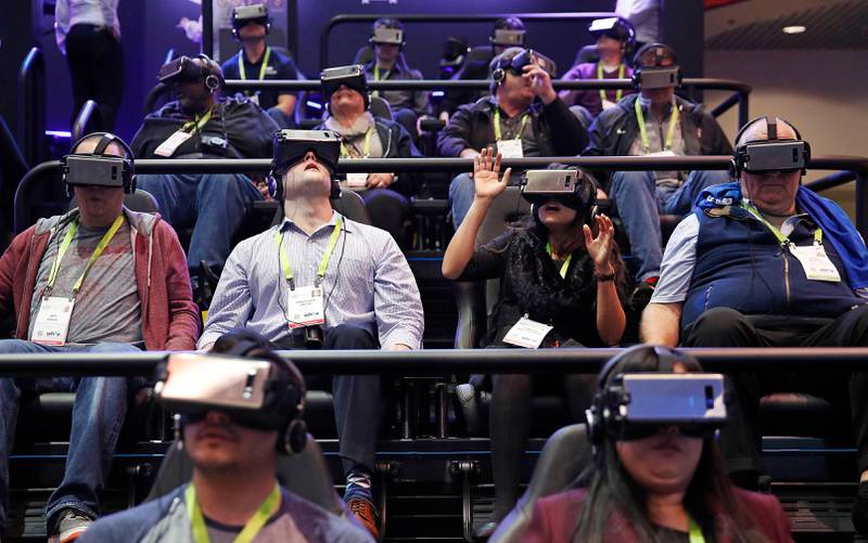 People look through Samsung Gear VR virtual reality goggles at the Samsung booth during CES International, Tuesday, Jan. 9, 2018, in Las Vegas. (AP Photo/John Locher)
