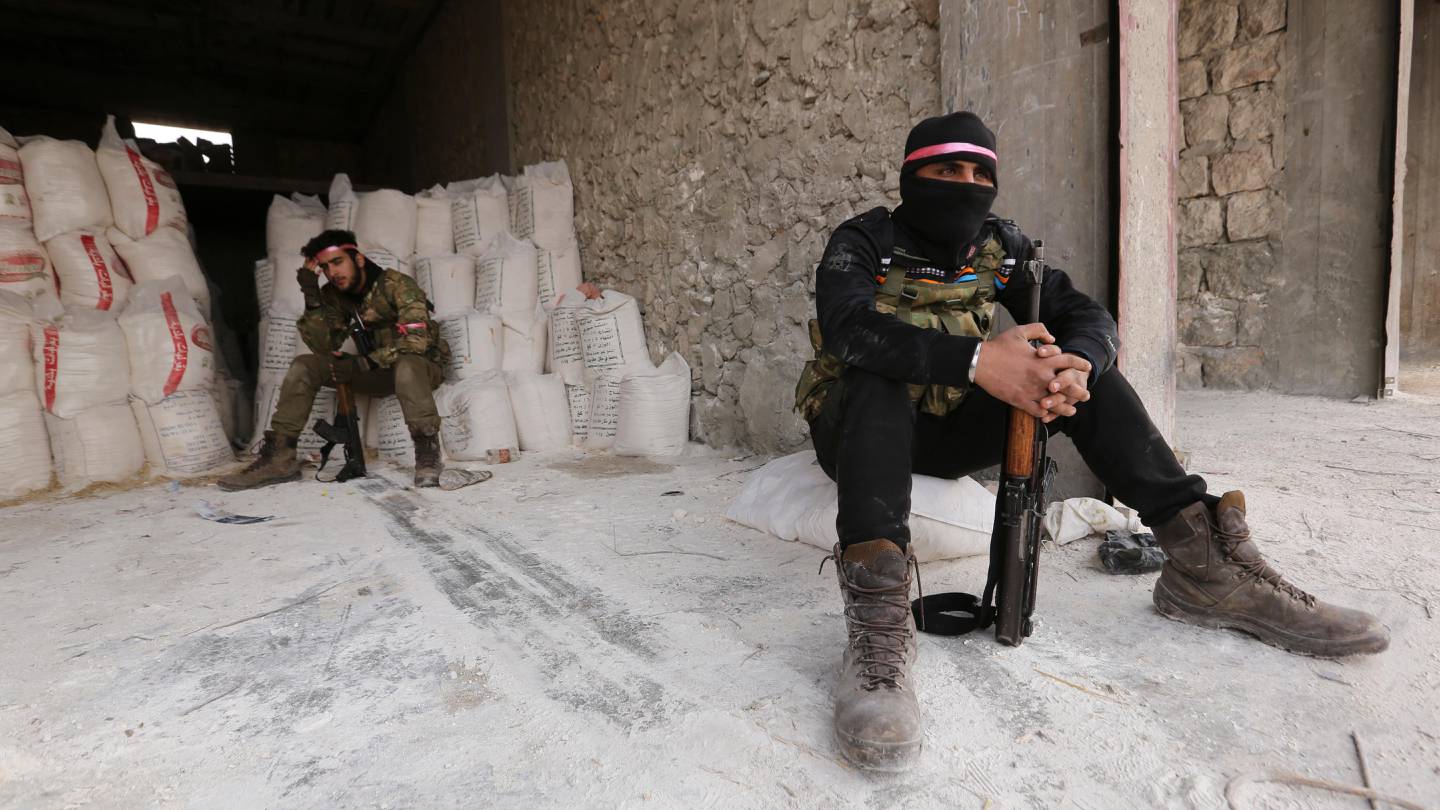 Turkish backed Syrian fighters prepare to go to a frontline near the village of Neirab, in Idlib province, Syria, Monday, Feb. 24, 2020. (AP Photo/Ghaith Alsayed)