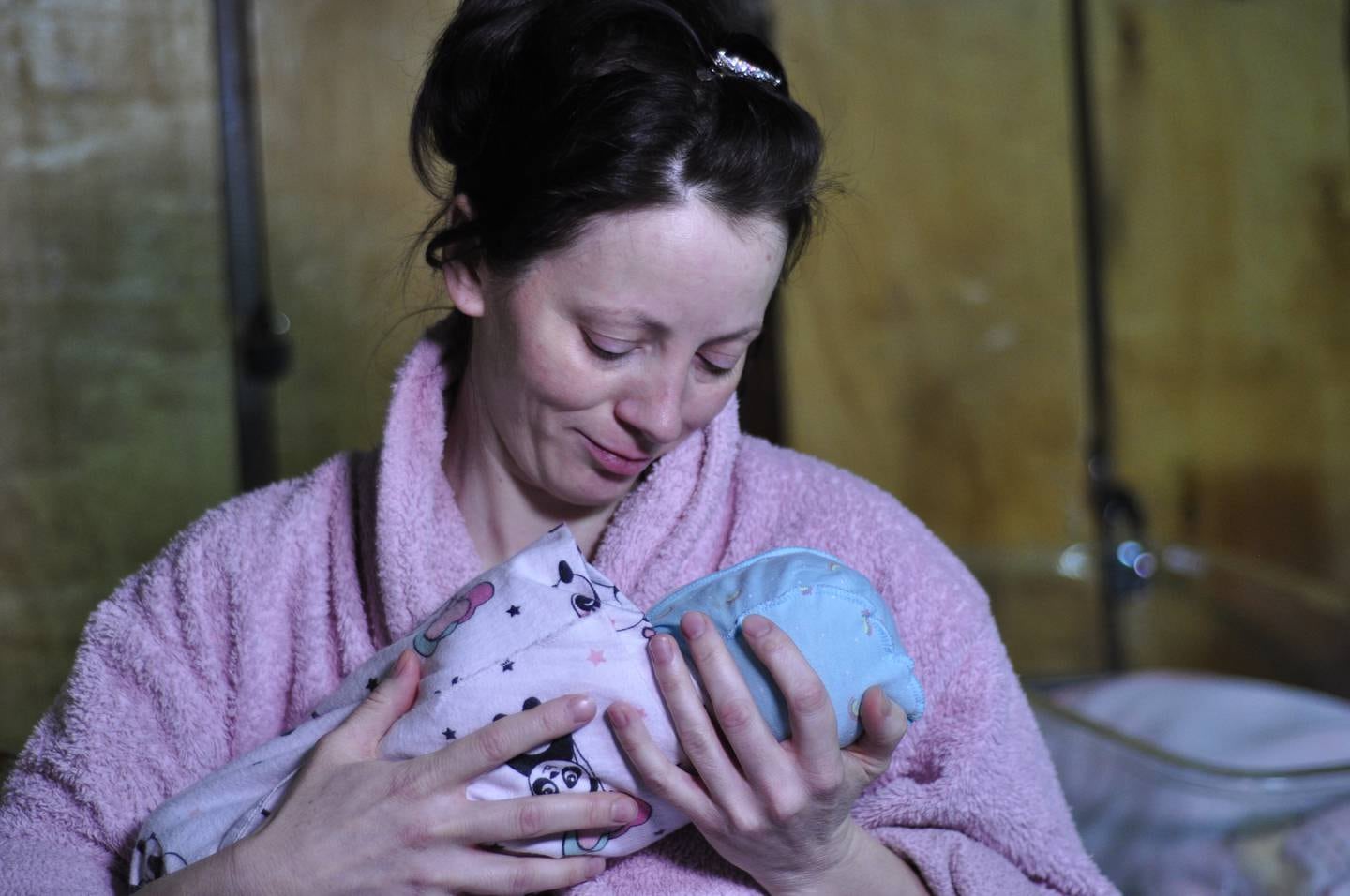 On 7 March 2022 at Kyiv Regional Perinatal Centre in Ukraine, Yuliya, 38, holds her newborn baby, Vera, siting on a bed in the makeshift ward in the Centre's basement, days after giving birth. “We’re sitting here in the basement, we’ve been crying,” Yuliya says. “It’s terrifying to see smoke and shelling. We’re doing everything we can to save our children, our futures.” It took Yuliya two days on foot to travel here from her home outside Kyiv. With the conflict escalating, Yuliya had no choice but to try to find a safe place to deliver her child. She says there were times during the journey when she worried she might not make it here at all. “I had to travel across fields and through forests,” she says, adding that due to some other health issues, not every facility would have been able to help her deliver her child. “But thanks to God and the doctors, I now have a baby and I’m still alive.” Tearfully, she says, “I just want us all to stay alive ... I want peace.”

In partnership with the Kyiv City Administration, UNICEF is providing urgent medical equipment, hygiene products and supplies to maternity hospitals and children’s hospitals all over Kyiv, including the Kyiv Regional Perinatal Centre. 

The basement of the centre has been turned into a makeshift maternity ward. Most of the women here only leave the basement when they need to – when they need to wash or get something to eat. Nataliya Heynts, the centre director, says the situation has been catastrophic for families. “It’s impossible to be prepared for this,” she says. “It’s extremely cold, dark, and there are no plugs down here.” Medical staff work under extreme pressure, delivering children amid constant shelling and often without a stable power supply. Some staff have already fled with their families. Others, including Nataliya, are taking on multiple jobs at once. “I work as a cook, a doctor and an operating surgeon,” says Nataliya. “It is our respon