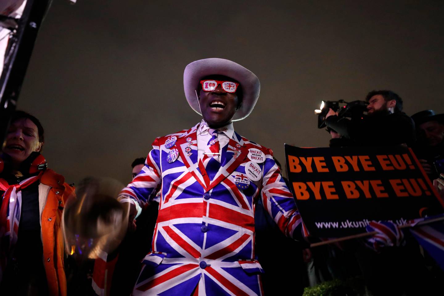 A Brexit supporter takes part in a rally during a rally at the Parliament square in London, Friday, Jan. 31, 2020. Britain officially leaves the European Union on Friday after a debilitating political period that has bitterly divided the nation since the 2016 Brexit referendum. (AP Photo/Frank Augstein)