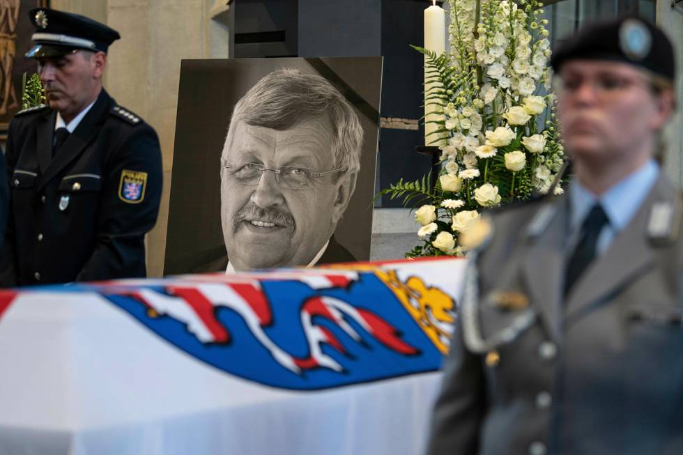 FILE-In this June 13, 2019 file photo a picture of Walter Luebcke stands behind his coffin during the funeral service in Kassel, Germany. German authorities say they have arrested a 45-year-old man in connection with their investigation into the slaying of a regional official from Chancellor Angela MerkelÄôs party. (Swen Pfoertner/dpa via AP)