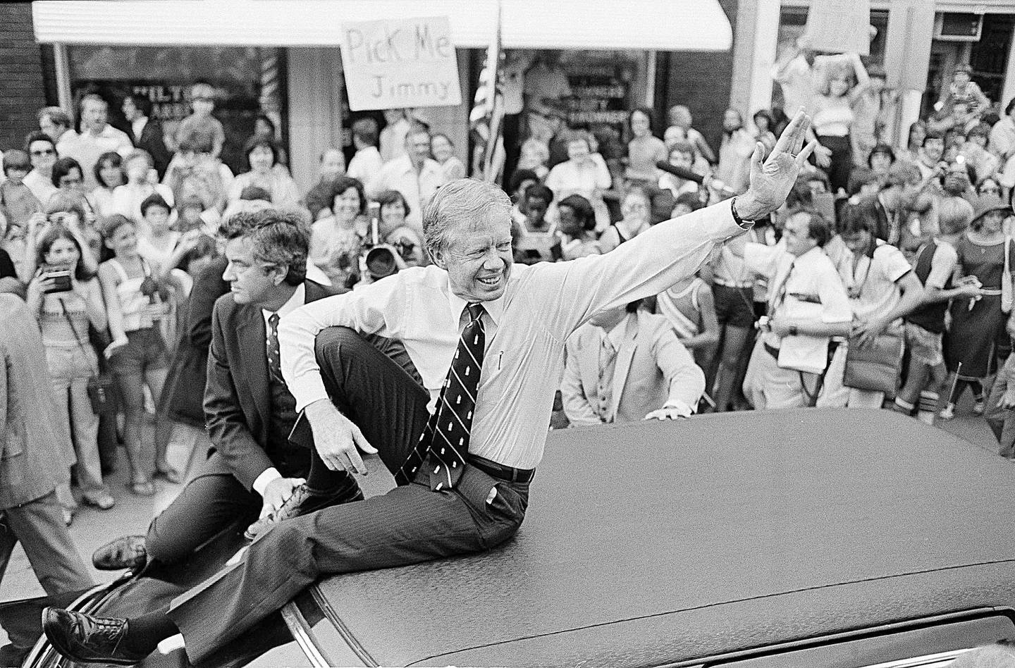 FILE - President Jimmy Carter waves from the roof of his car along the parade route through Bardstown, Ky., July 31, 1979. Well-wishes and fond remembrances for the former president continued to roll in Sunday, Feb. 19, 2023, a day after he entered hospice care at his home in Georgia. (AP Photo/Bob Daugherty, File)