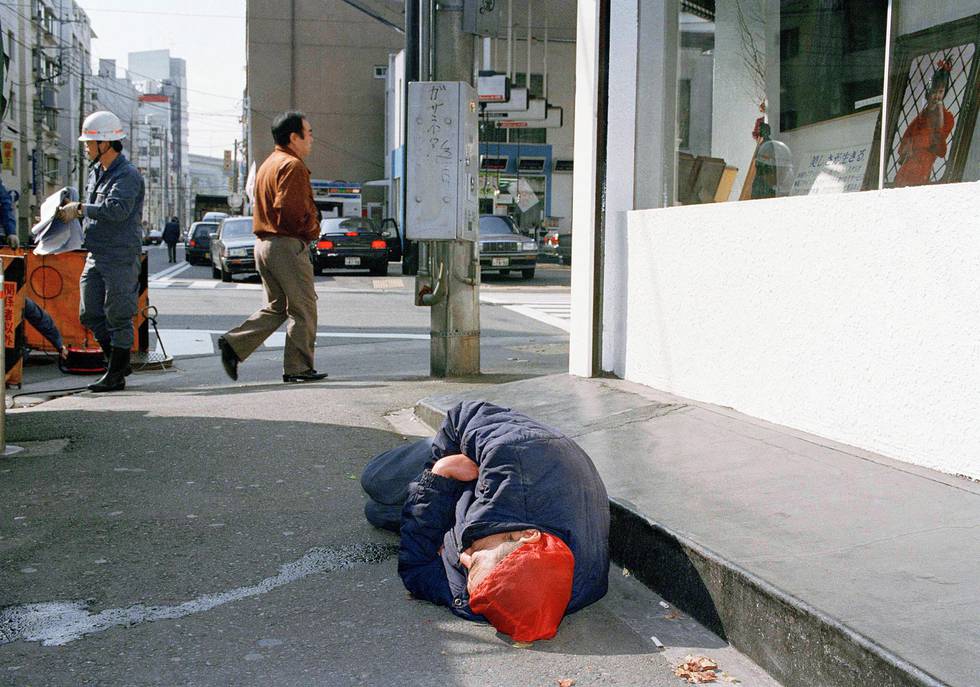 A homeless man lies sleeping in an alley of the Felicity Street neighborhood in Yokohama, Japan on Oct. 13, 1992. The district, attractive to illegal aliens, is a small pocket of poverty and distress in a nation otherwise known as an economic miracle. (AP Photo/Itsuo Inouye)