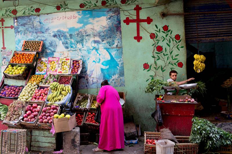 In this Sunday, Nov. 11, 2012 picture, a Coptic woman shops for vegetables in the Moqattam area, Cairo, Egypt. Egypt's Christian minority, about 10 percent of the population of more than 80 million, has long complained of discrimination. But Christians fear things are reaching a crisis point since the ouster of President Hosni Mubarak nearly two years ago and the subsequent rise to power of Islamists. The Church itself is undergoing a major transition: A new pope, Tawadros II, is to be enthroned in Cairo on Sunday, succeeding Shenouda III, the man who led the Church for 40 years and was revered by Copts as their protector until his death in March. (AP Photo/Bernat Armangue) 