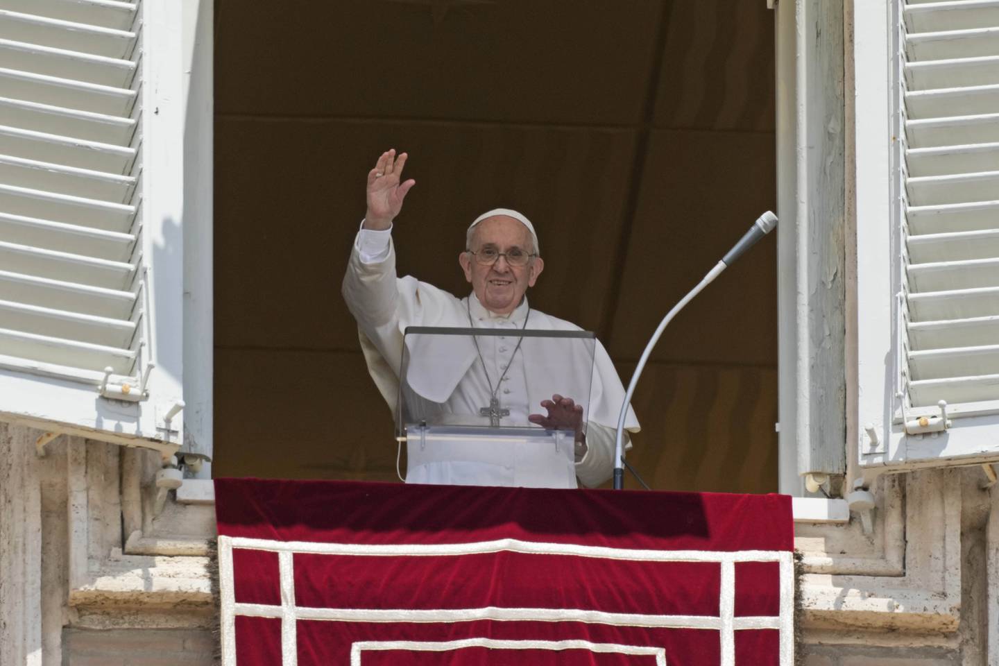 Pope Francis salutes the crowd as he arrives for the Angelus noon prayer from the window of his studio overlooking St.Peter's Square, at the Vatican, Sunday, July 18, 2021. (AP Photo/Alessandra Tarantino)