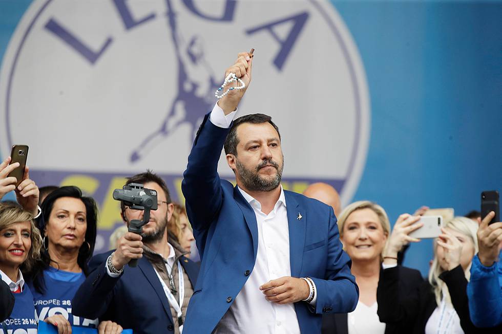 FILE - In this file photo taken on May 18, 2019, Matteo Salvini holds a rosary as he gives his speech during a rally organized with leaders of other European nationalist parties, ahead of the May 23-26 European Parliamentary elections, in Milan, Italy. For months now, Salvini _ a divorced father of two children by two different women _ has been kissing rosaries, invoking the Madonna and quoting St. John Paul II at political rallies in a bid to rally Italian Catholics behind his nationalist message. (AP Photo/Luca Bruno)