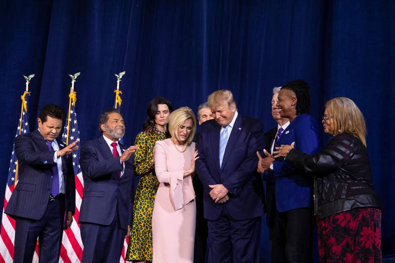 Faith leaders pray over President Donald Trump during an "Evangelicals for Trump Coalition Launch" at King Jesus International Ministry, Friday, Jan. 3, 2020, in Miami. (AP Photo/ Evan Vucci)