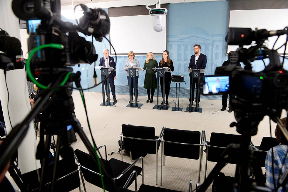 Finland government ministers announce new measures to fight the COVID-19 virus outbreak, with from left, Pekka Haavisto Minister for Foreign Affairs, Anna-Maja Henriksson Minister of Justice, Maria Ohisalo Minister of the Interior, Prime Minister Sanna Marin and Timo Harakka Minister of Transport and Communications, during a sparsely attended press conference in Helsinki, Finland, Tuesday March 17, 2020. For most people, the new COVID-19 coronavirus causes only mild or moderate symptoms, but for some it can cause very severe illness.(Mikko Stig/Lehtikuva via AP)