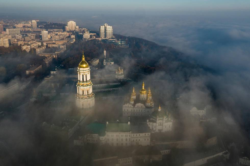 FILE - In this Saturday, Nov. 10, 2018 file photo, an aerial photo of the thousand-year-old Monastery of Caves, also known as Kiev Pechersk Lavra, the holiest site of Eastern Orthodox Christians is taken through morning fog during sunrise in Kiev, Ukraine. Ukraine's president has promised the country's Orthodox Christian faithful they will be free to remain part of the Russian Orthodox Church after the creation of an independent Ukrainian church. Amid deteriorating ties with Moscow, Kiev has been pushing for the creation of an autocephalous Ukrainian Orthodox Church that would be free of control from the Moscow Patriarchate. (AP Photo/Evgeniy Maloletka, File)