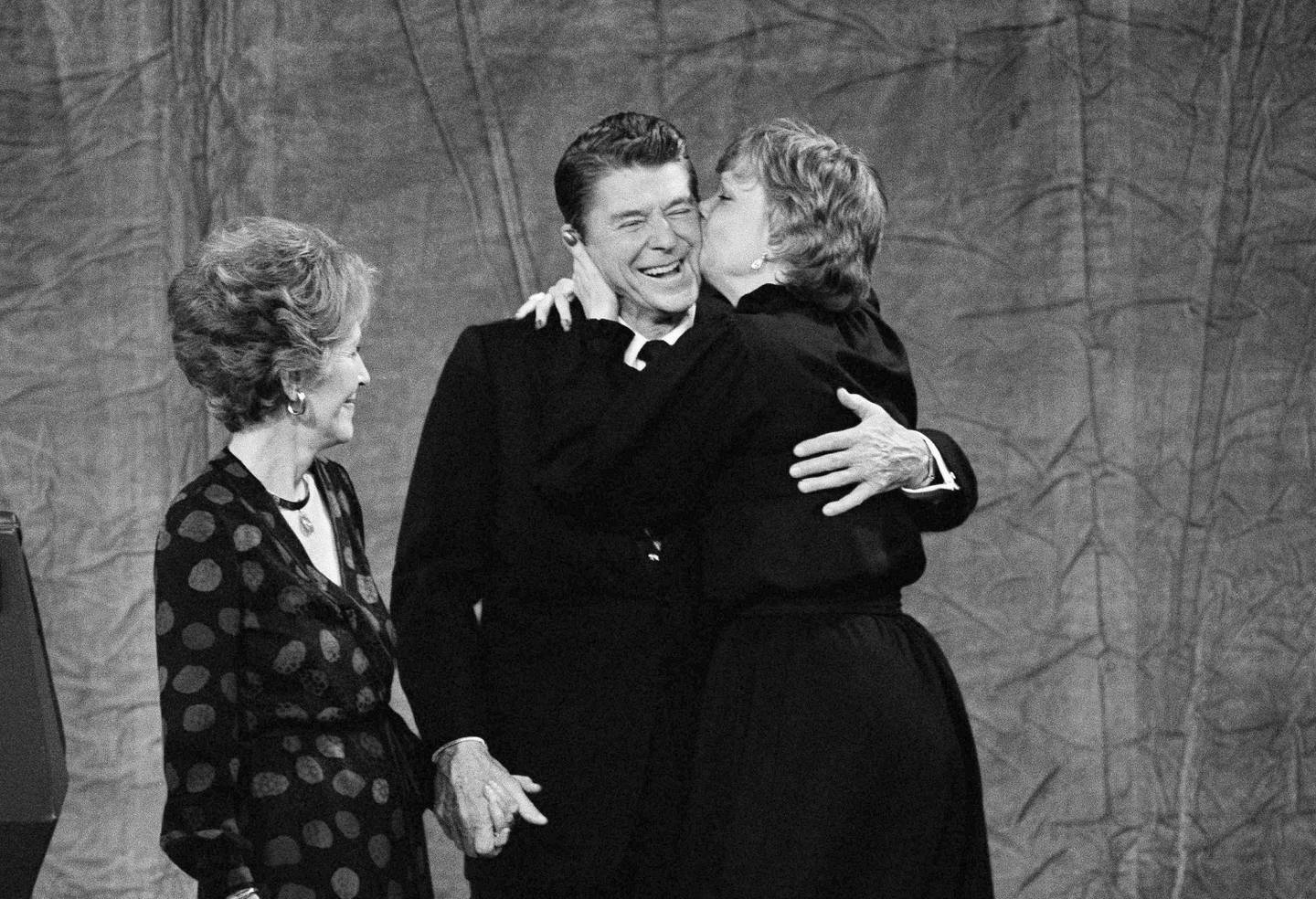 Maureen Reagan, right, gives a kiss to her father, president-elect Ronald Reagan, while Nancy Reagan looks on, Nov. 5, 1980. Reagan shared center stage with his family at Century Plaza Hotel in Los Angeles after defeating President Jimmy Carter in the presidential election. (AP Photo)
