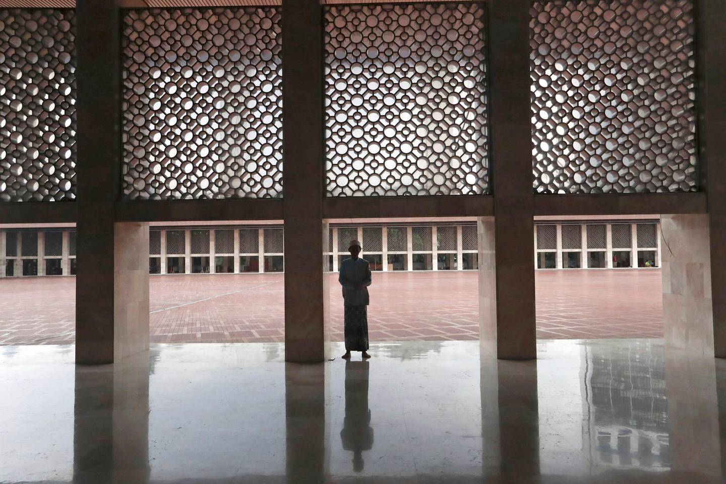A Muslim man prays at Istiqlal Mosque in Jakarta, Indonesia, Friday, March 20, 2020. The grand mosque in Indonesia's capital, one of the largest mosque in Southeast Asia, which is usually packed with thousands of Muslims during Friday prayers, decided to cancel mass prayers for the next two weeks to curb coronavirus spread. The vast majority of people recover from the new coronavirus. According to the World Health Organization, most people recover in about two to six weeks, depending on the severity of the illness. (AP Photo/Tatan Syuflana)