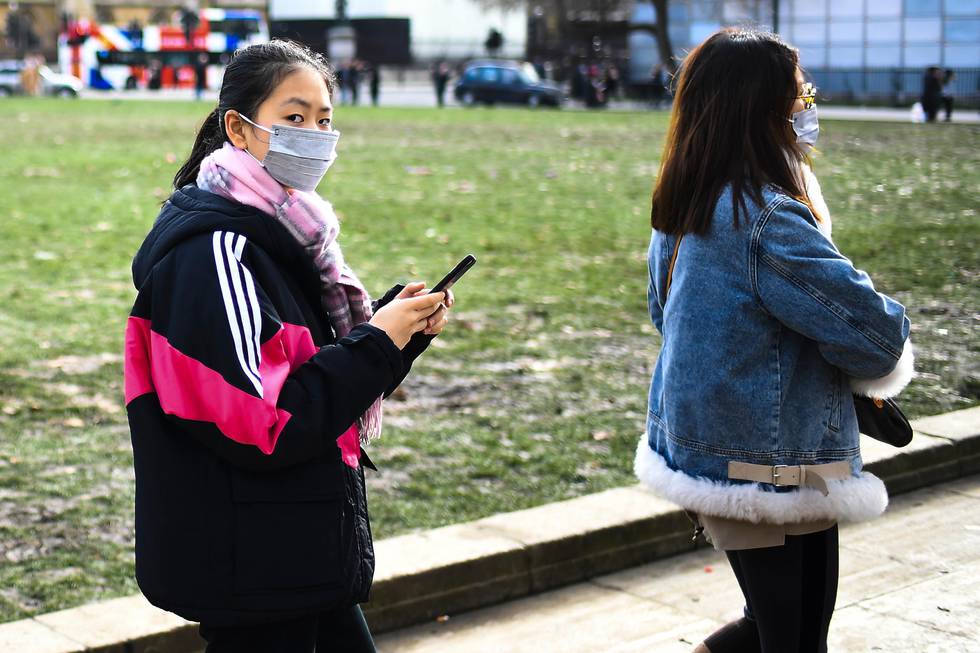 Two women in masks walk in Parliament Square, in London, Saturday, Feb. 1, 2020. Two cases of coronavirus have been confirmed in Britain. The World Health Organization declared a global health emergency over the coronavirus outbreak. (AP Photo/Alberto Pezzali)