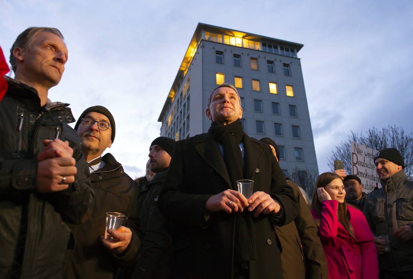 Bjoern Hoecke, chairman of the far-right Alternative fuer Deutschland (AfD) in Thuringia and candidate of the party for the state governor elections, 4th of left, attends a so called 'A light for democracy' silence demonstration, initiated by the far-right Alternative for Germany (AfD) party in Erfurt, central Germany, Tuesday, March 3, 2020. The parliament of the eastern German state Thuringia will elect a new governor on Wednesday, March 4, 2020. (AP Photo/Jens Meyer)