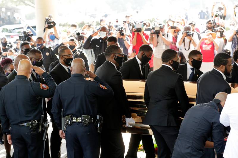 Texas Southern University police salute as family and guests arrive for George Floyd's funeral service at The Fountain of Praise Church on Tuesday, June 9, 2020, in Houston. (AP Photo/Eric Gay)