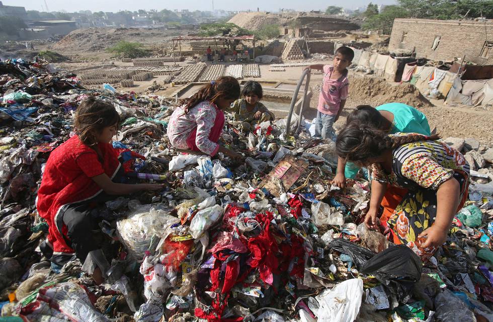 Pakistan children sort through garbage for recycleable items to sell, at a dump in Karachi, Pakistan, Thursday, April 4, 2019. (AP Photo/Fareed Khan)