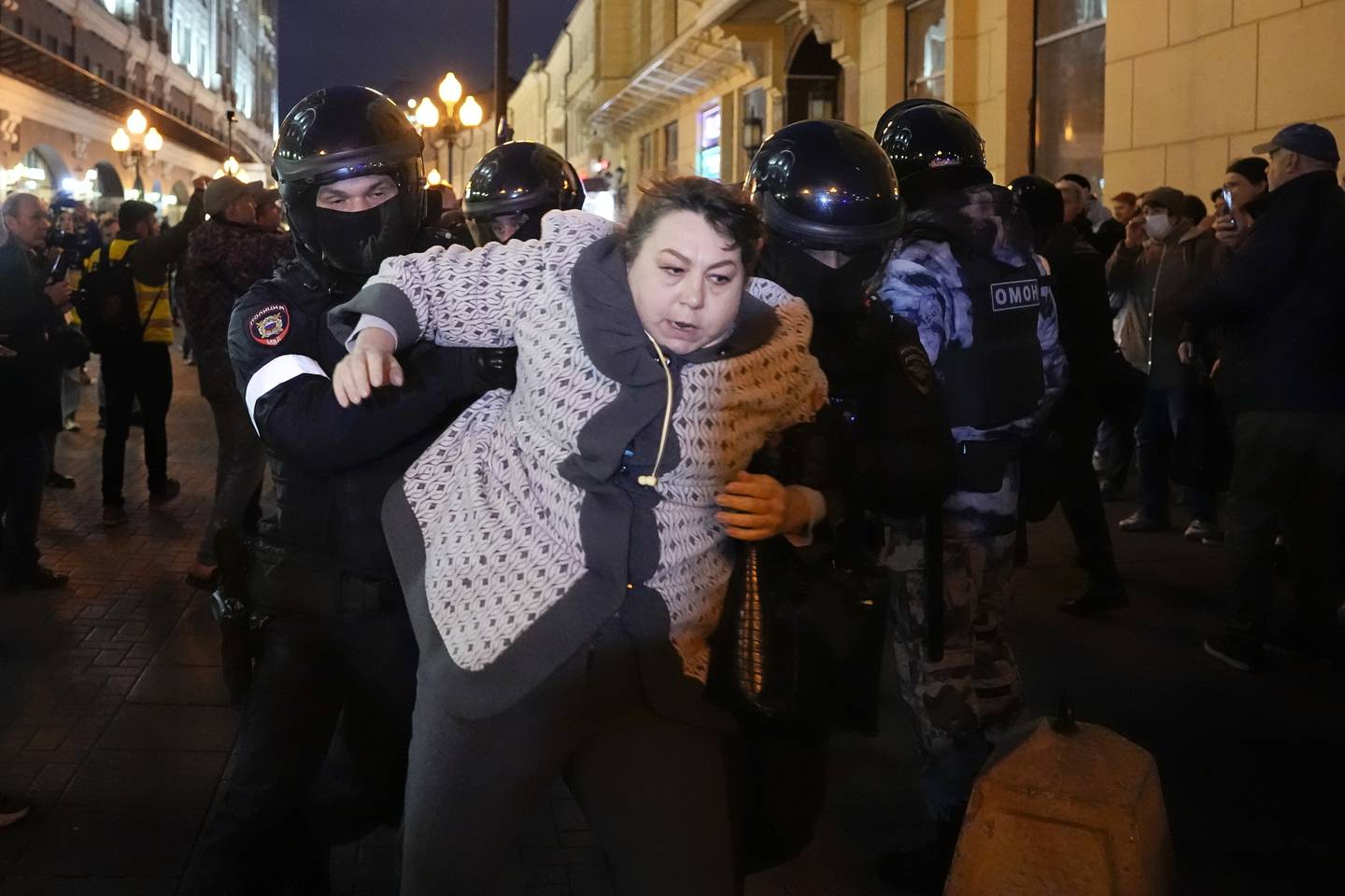 Riot police detain a woman during a protest against mobilization in Moscow, Russia, Wednesday, Sept. 21, 2022. Russian President Vladimir Putin has ordered a partial mobilization of reservists in Russia, effective immediately. (AP Photo/Alexander Zemlianichenko)