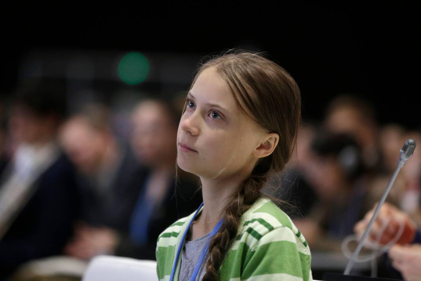 FILE - In this Wednesday, Dec. 11, 2019, file photo, Swedish climate activist Greta Thunberg listens to speeches before addressing the U.N. climate conference n Madrid, Spain. On Friday, Dec. 13, 2019, The Associated Press reported on a video circulating online and inaccurately described, in some social media posts, as showing Thunberg firing an AR-15 rifle. The shooter in the video is another young Swede named Emmy Slinge. (AP Photo/Paul White)