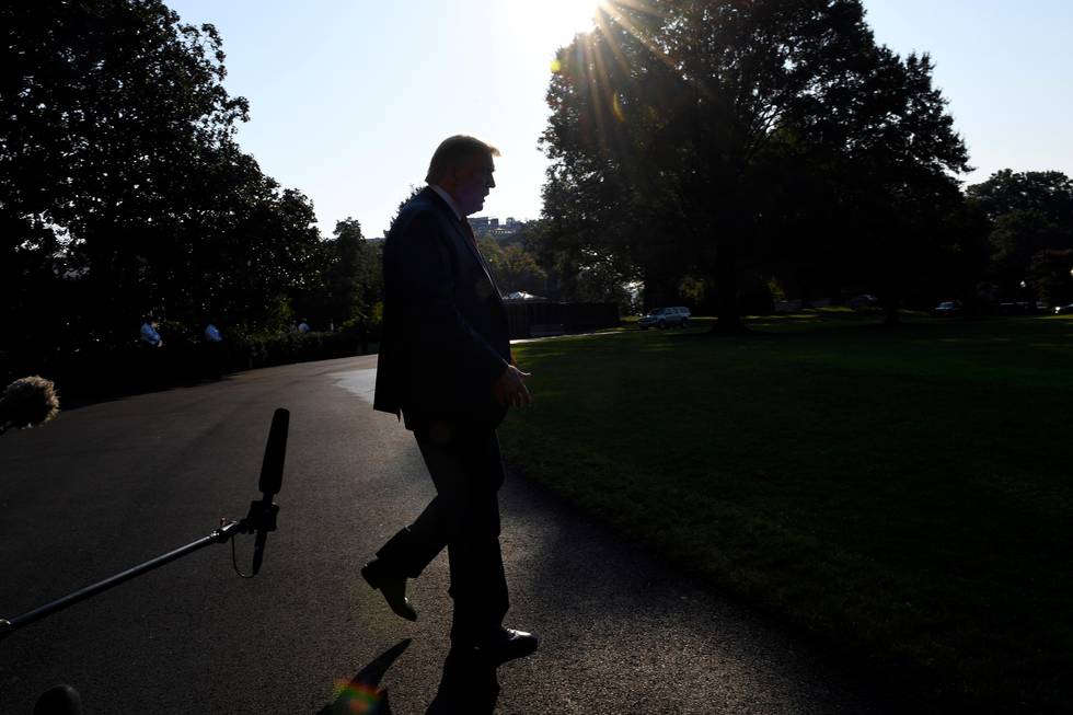 FILE - In this Sunday, Sept. 22, 2019, file photo President Donald Trump walks away after talking with reporters on the South Lawn of the White House in Washington as he prepares to board Marine One for the short trip to Andrews Air Force Base. The Democratic impeachment inquiry may give Trump extra motivation to end his trade war with China, claim credit for a policy victory and divert a little attention from a congressional investigation into his dealings with Ukraine. (AP Photo/Susan Walsh, File)