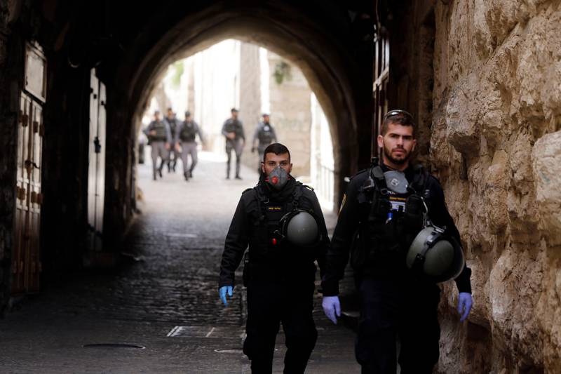 Israeli police patrols deserted street in Jerusalem's Old City, in Jerusalem, Monday, March 23, 2020. In Israel daily life has largely shut down with coronavirus cases multiplying greatly over the past week, (AP Photo/Mahmoud Illean)