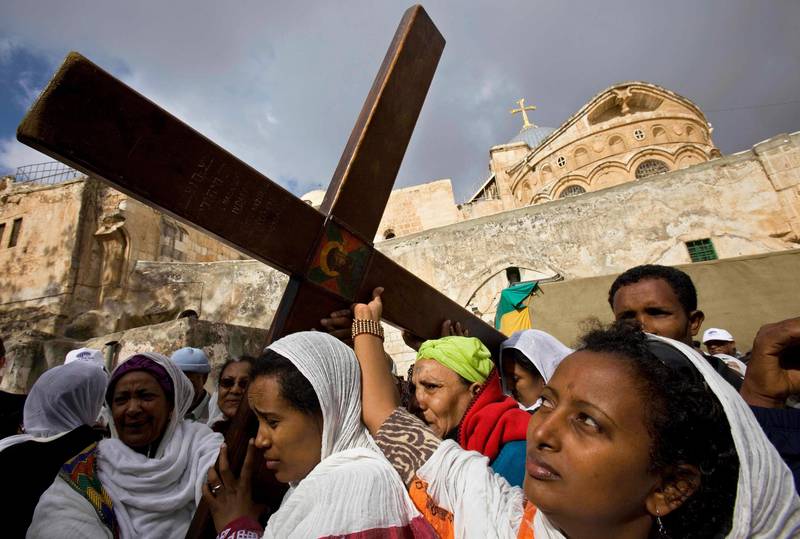 Pilgrims from the Ethiopian Christian Orthodox community carry a cross during Good Friday processions in the Church of the Holy Sepulcher, traditionally believed to be the site of the crucifixion, in Jerusalem's Old City, Friday, April 17, 2009. Christian followers of the Eastern Churches are marking the solemn period of Easter. (AP Photo/Bernat Armangue)