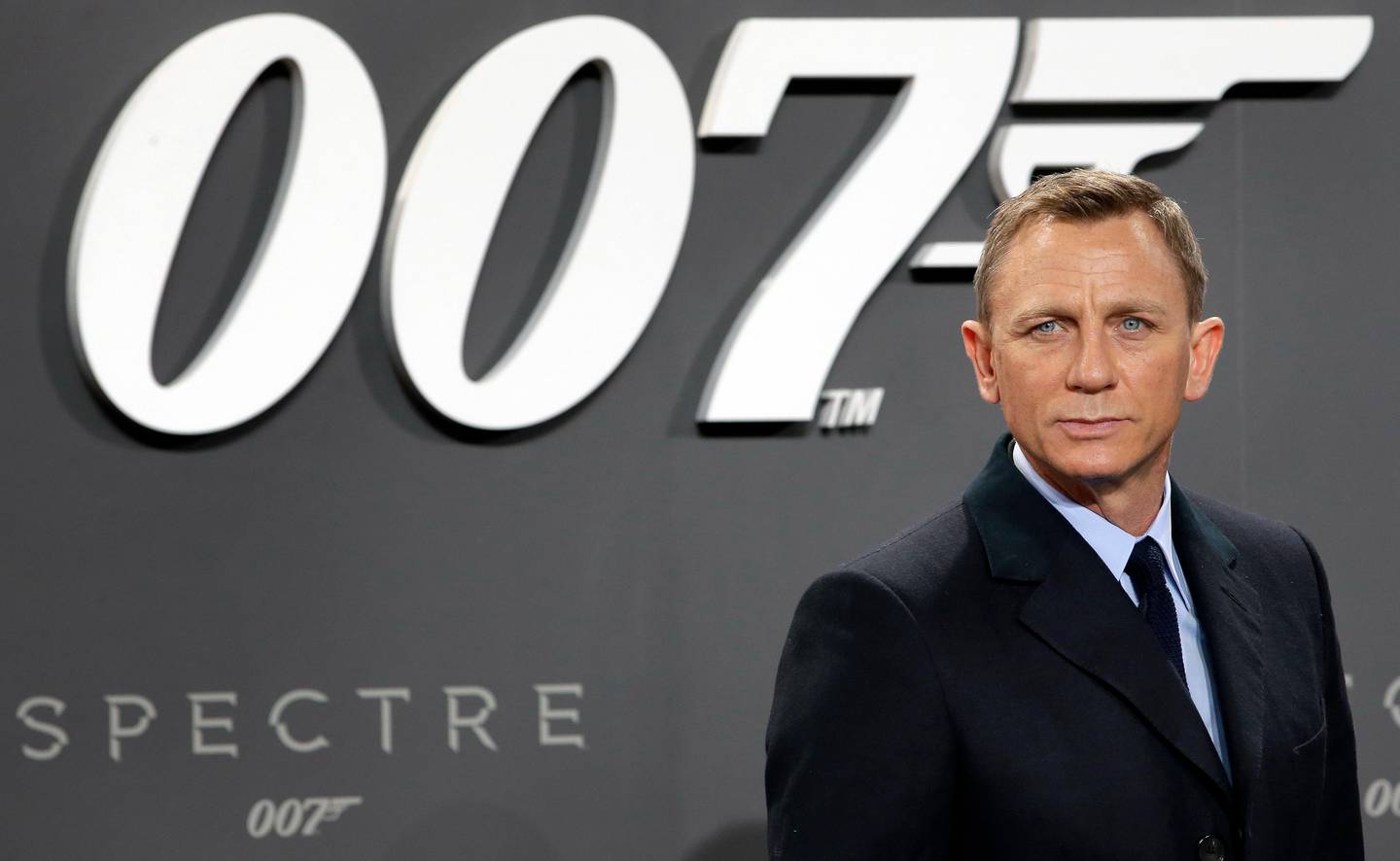 FILE - This is a Wednesday, Oct. 28, 2015 file photo of actor Daniel Craig poses for the media as he arrives for the German premiere of the James Bond movie 'Spectre' in Berlin, Germany. The release of the James Bond film No Time To Die has been pushed back several months because of global concerns about coronavirus. MGM, Universal and producers Michael G. Wilson and Barbara Broccoli announced on Twitter Wednesday that the film would be pushed back from its April release to November 2020.  (AP Photo/Michael Sohn/File)