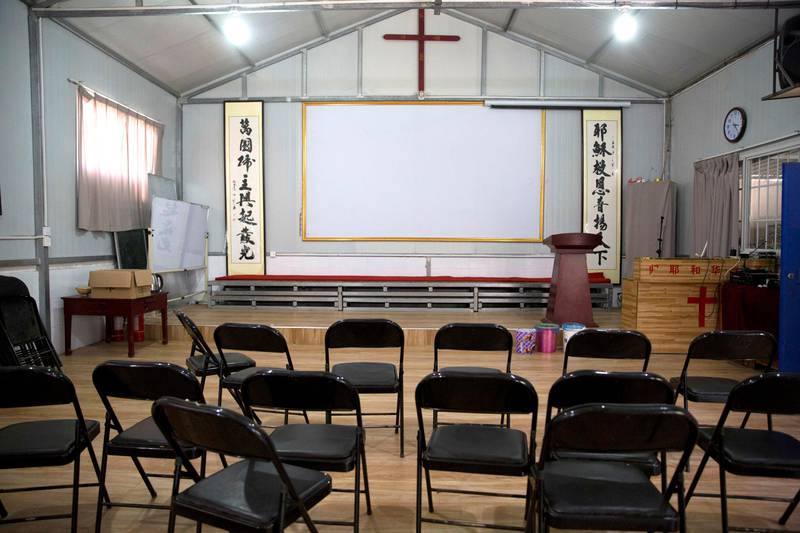 In this photo taken Monday, June 4, 2018, Chinese calligraphy which reads "All nations belong to the Lord arising to shine" at left and "Jesus's salvation spreads to the whole world" at right are displayed below a crucifix in a house church shut down by authorities near the city of Nanyang in central China's Henan province. Under President Xi Jinping, China's most powerful leader since Mao Zedong, believers are seeing their freedoms shrink dramatically even as the country undergoes a religious revival. Experts and activists say that as he consolidates his power, Xi is waging the most severe systematic suppression of Christianity in the country since religious freedom was written into the Chinese constitution in 1982. (AP Photo/Ng Han Guan)