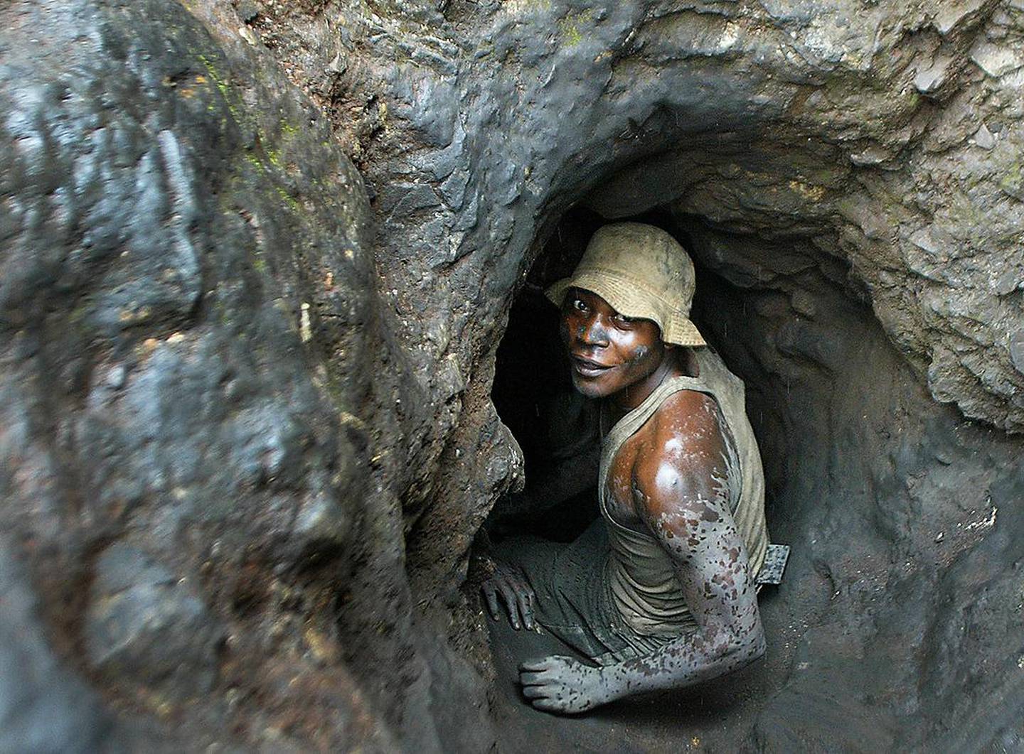 FILE - In this April 10, 2004 file photo, a man enters a tunnel dug with shovels in the Shinkolobwe cobalt mine, 35km (22 miles) from the town of Likasi in the Democratic Republic of Congo. U.N. Security Council Resolution 1540 of 2004 obligates governments to give a full accounting of their nuclear materials, but as U.S. President Barack Obama hosts a summit on nuclear security April 12-13 in Washington, many states have fallen short of the reporting deadline, including Congo, the source of the uranium for the first atomic bomb. (AP Photo/Schalk van Zuydam, File)