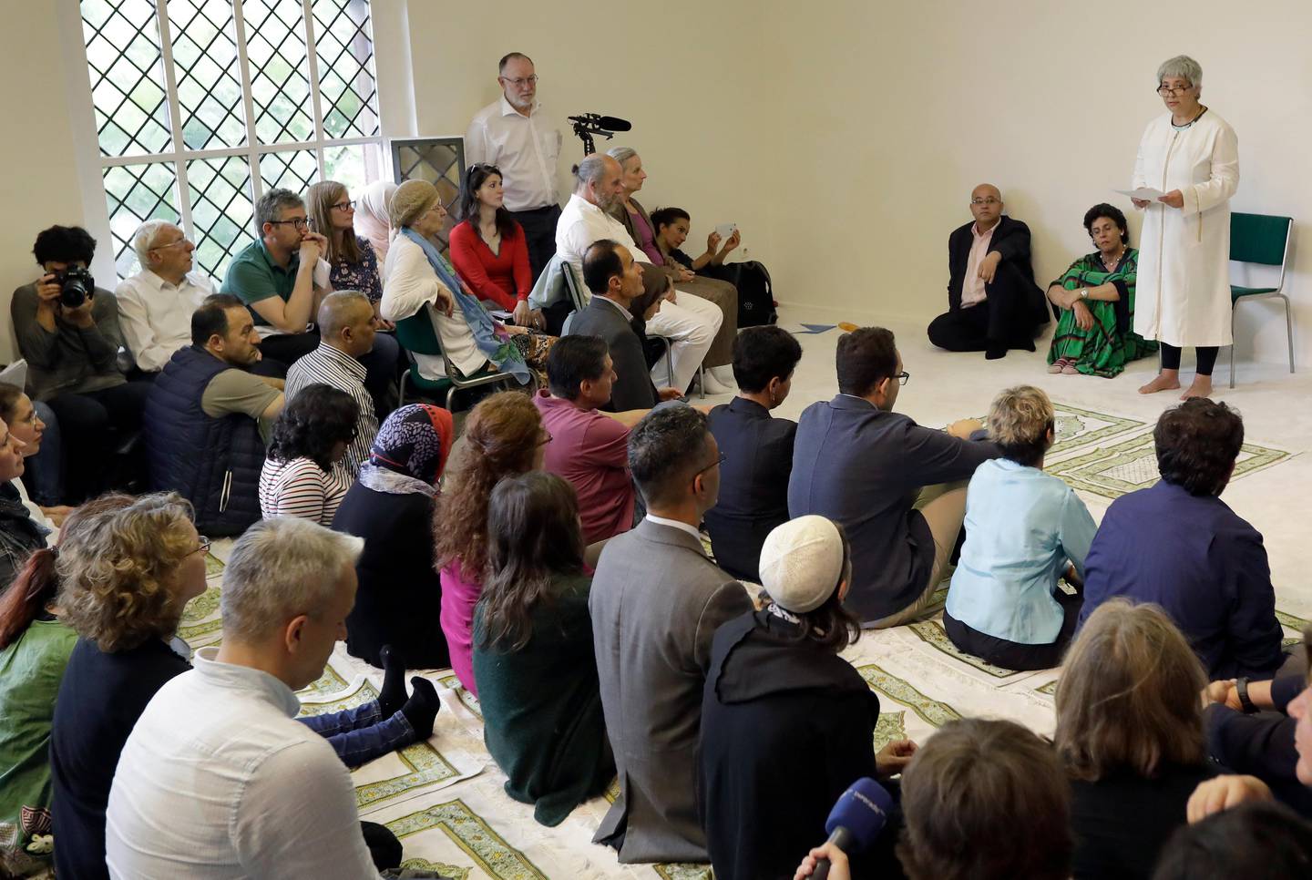 Seyran Ates, right, founder of the Ibn-Rushd-Goethe-Mosque preaches during the opening of the mosque in Berlin, Germany, Friday, June 16, 2017. Ates a daughter of Turkish immigrants has founded the first liberal mosque in Germany where men and women can pray together, homosexuals are welcome and Muslims of all sects can leave their inner-religious conflicts behind. (AP Photo/Michael Sohn)