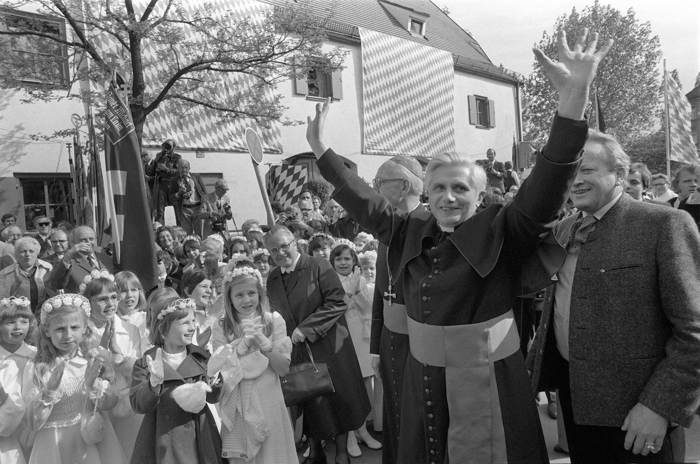 Joseph Ratzinger, the new archbishop of Munich and Freising, raises his arms to greet hundreds of believers at his arrival in the Bavarian capital Munich, Germany, on May 23, 1977. (AP Photo/Diether Endlicher)