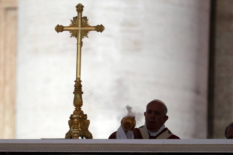 Pope Francis is silhouetted as he spreads incense on the altar during a Pentecost Mass in St. Peter's Square, at the Vatican, Sunday, June 9, 2019. The Pentecost Mass is celebrated on the seventh Sunday after Easter. (AP Photo/Gregorio Borgia)